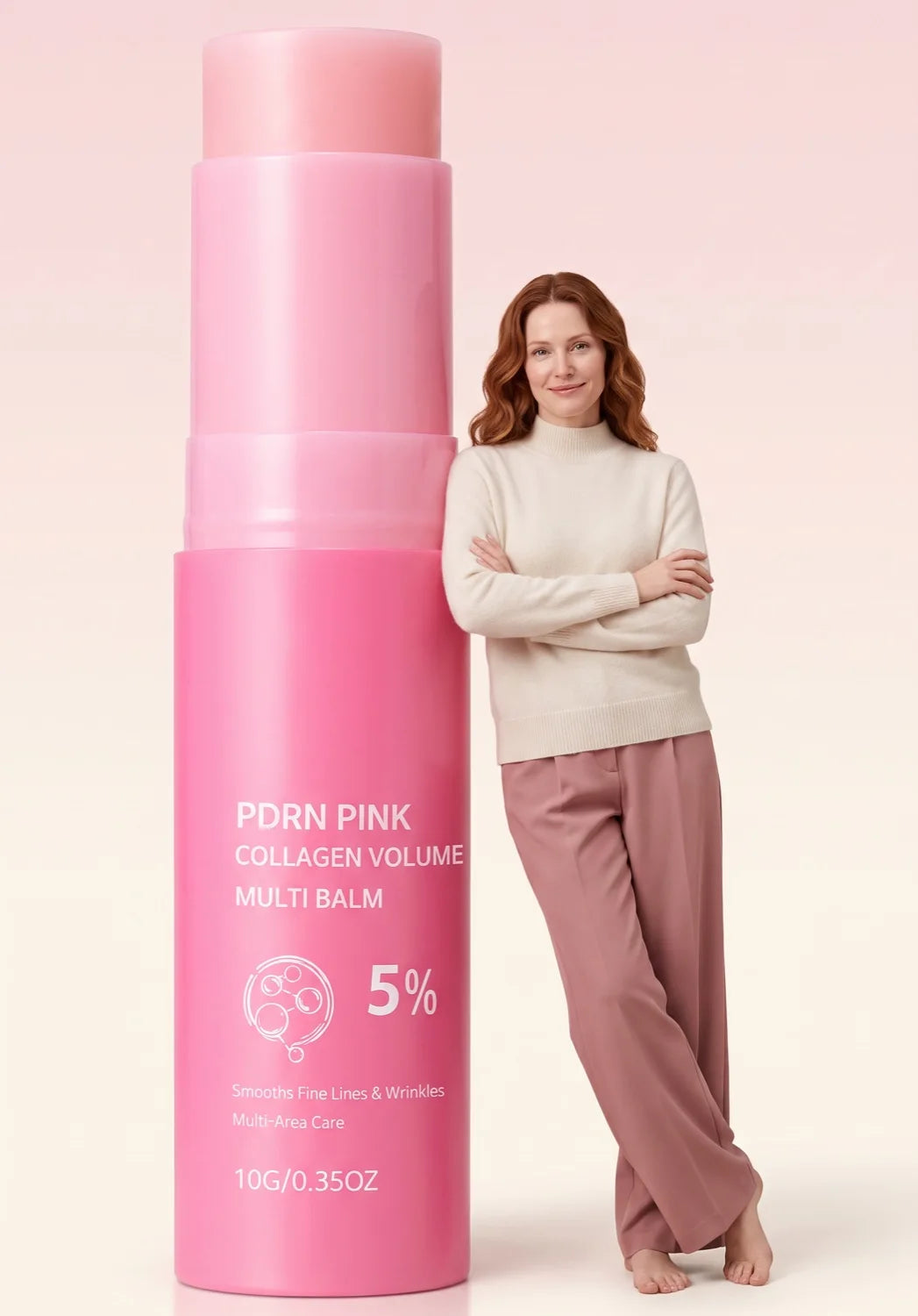 Woman in a cream sweater leaning against an oversized Volée Pink Balm stick