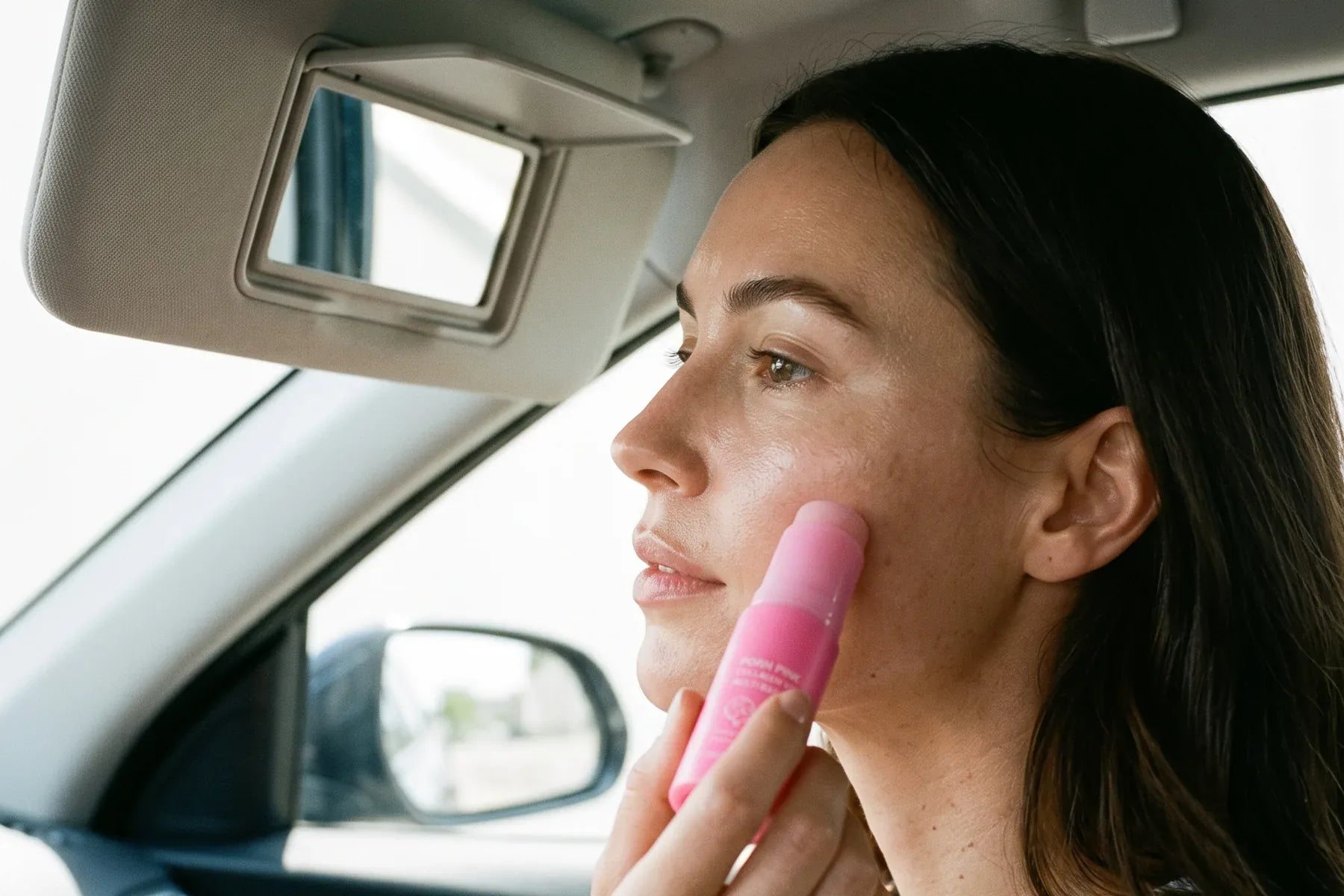 Pink Balm stick peeking out of a tote bag on the street